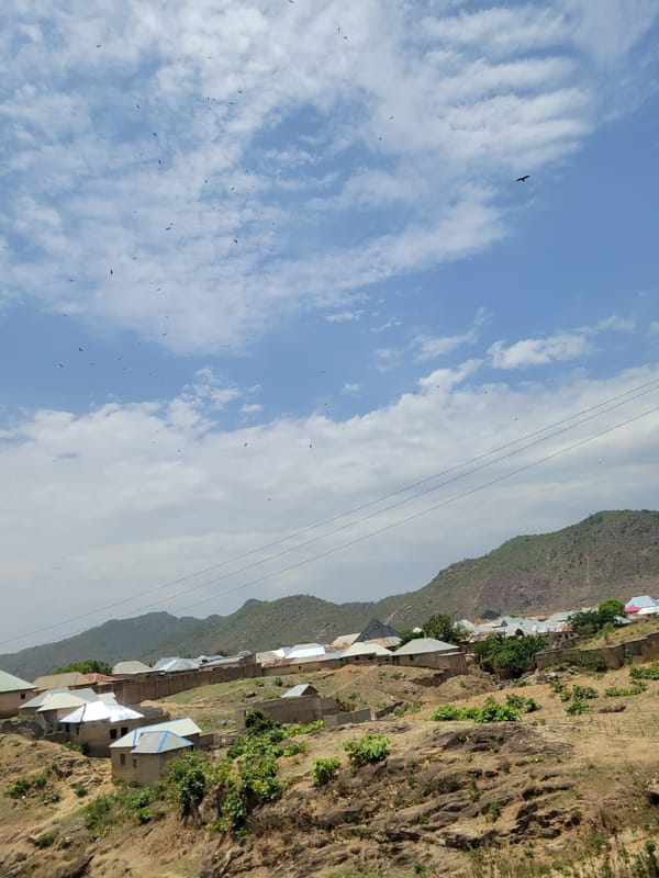 Hillside village with colorful roofs documented in Tilde, Nigeria