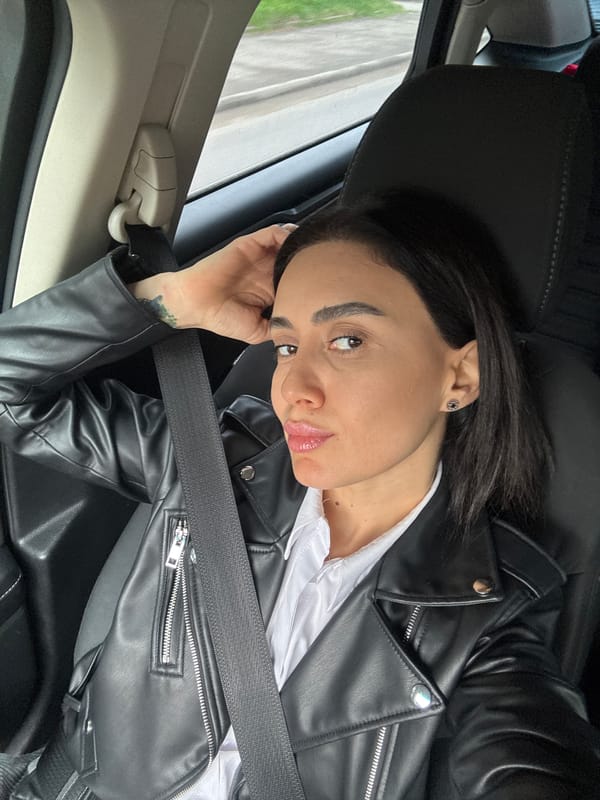 Woman in leather jacket observed in car in Tbilisi