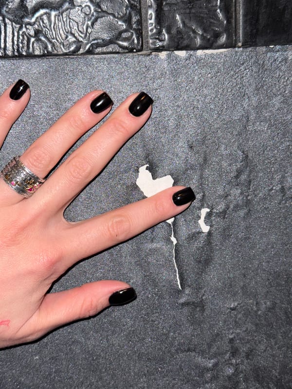 Hand with black nails, silver ring observed in Sofia