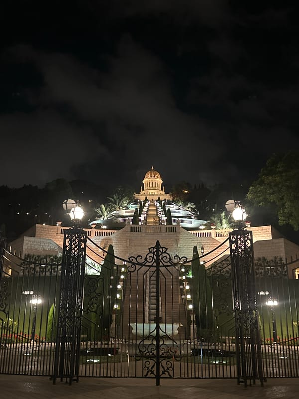 Baháʼí World Centre lit up after dark in Haifa