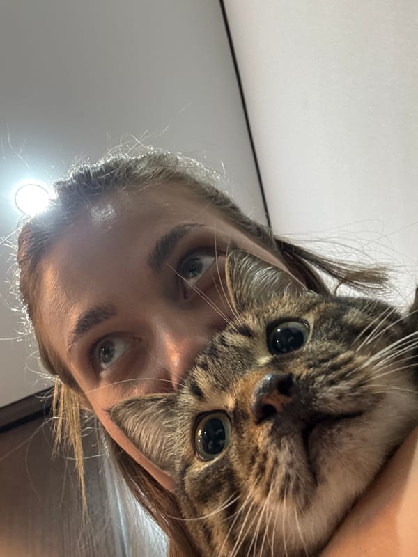 Woman and tabby cat share quiet moment in Chernushka