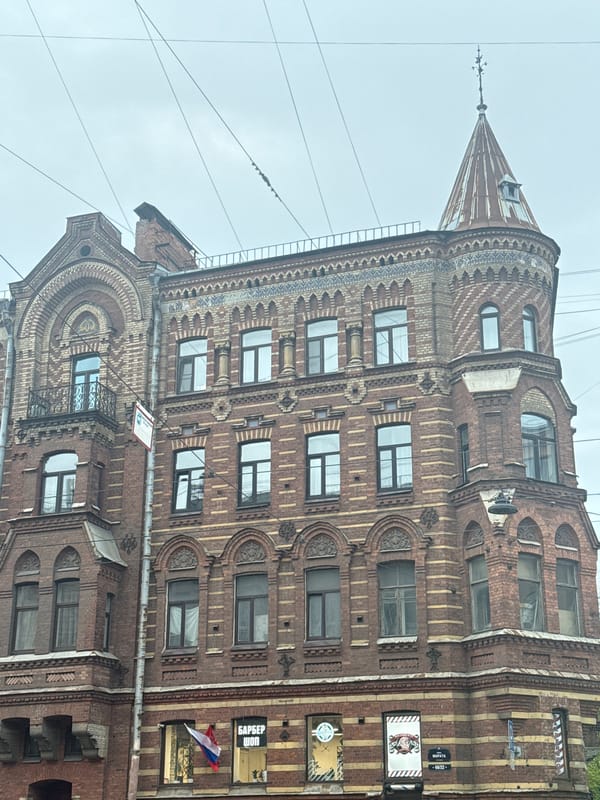 Family crosses Saint Petersburg street carrying orange bags