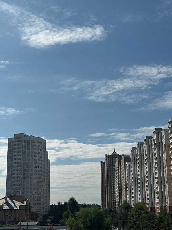 Podolsk apartment blocks under a bright summer morning sky