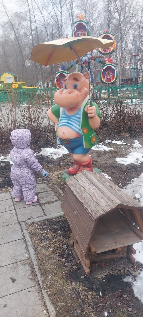 Winter park scenes documented in Novosibirsk featuring child, statues