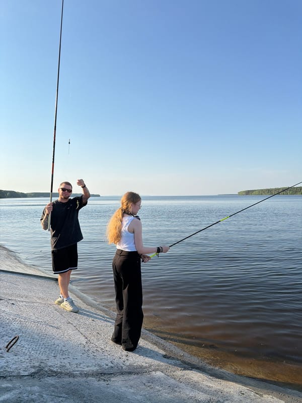 Two anglers fish from concrete pier in Chaikovsky, Russia
