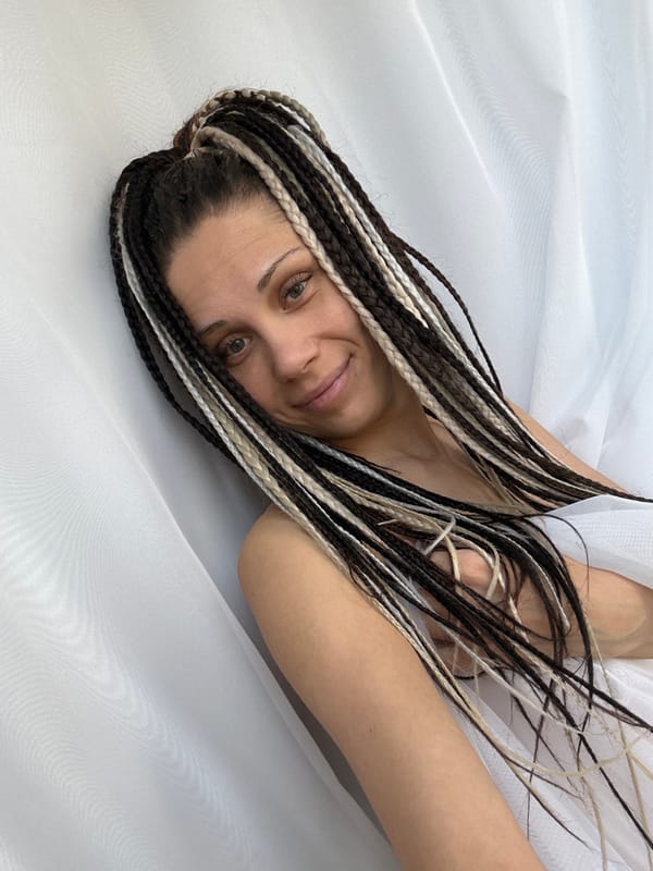Woman with braided hair photographed on white surface