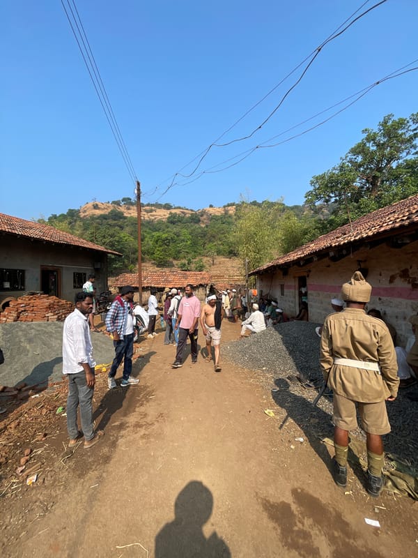 People queue along dirt path in Sonurle, India