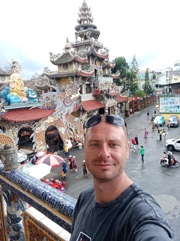 Tourist documents ornate Vietnamese pagoda with intricate mosaic artwork