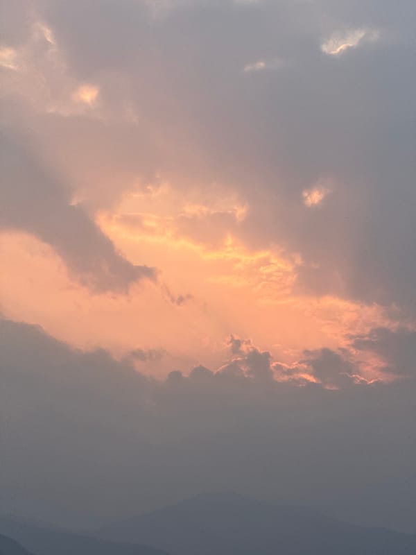Sunset illuminates clouds and grassland in Pokhara, Nepal