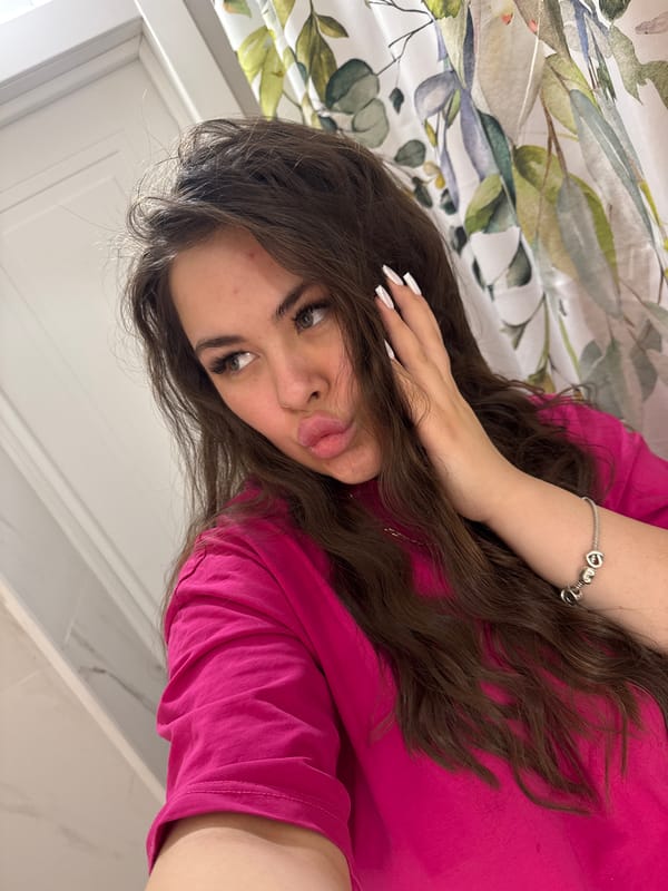 Young woman takes playful selfie indoors in Russia