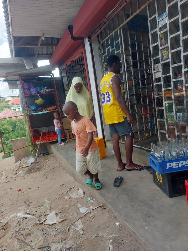 Daily street life captured around Dar es-Salaam storefronts