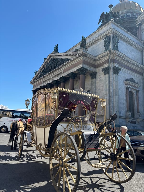 Horse-drawn carriage near Saint Petersburg's landmark cathedrals on a sunny afternoon
