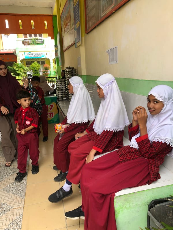 Catering truck delivers food trays to a Lhokseumawe school