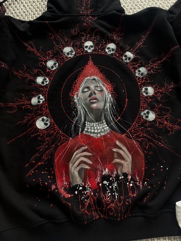 Artist documents gothic hoodie painting project in Krasnoyarsk