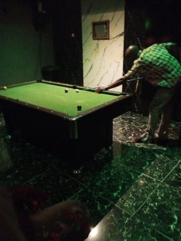 Live drums, DJ set, and pool at a neon-lit club night