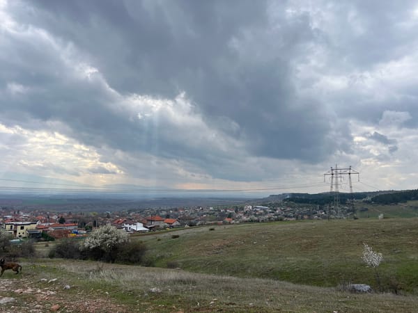 Sunlight breaks through clouds over residential settlement