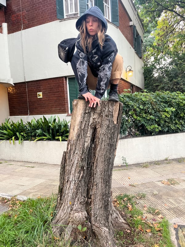 Youth photographed on tree stump in Olivos, Argentina