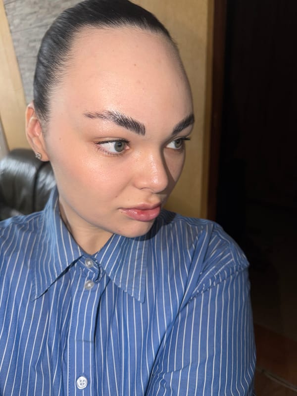 Woman in striped shirt observed looking upward in Perm
