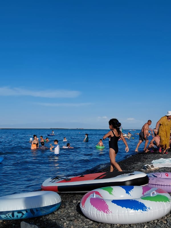 Crowded summer day at Ақши's pebble beach, Kazakhstan