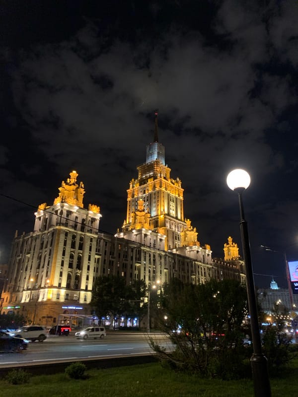 Illuminated spired building photographed in urban nighttime scene