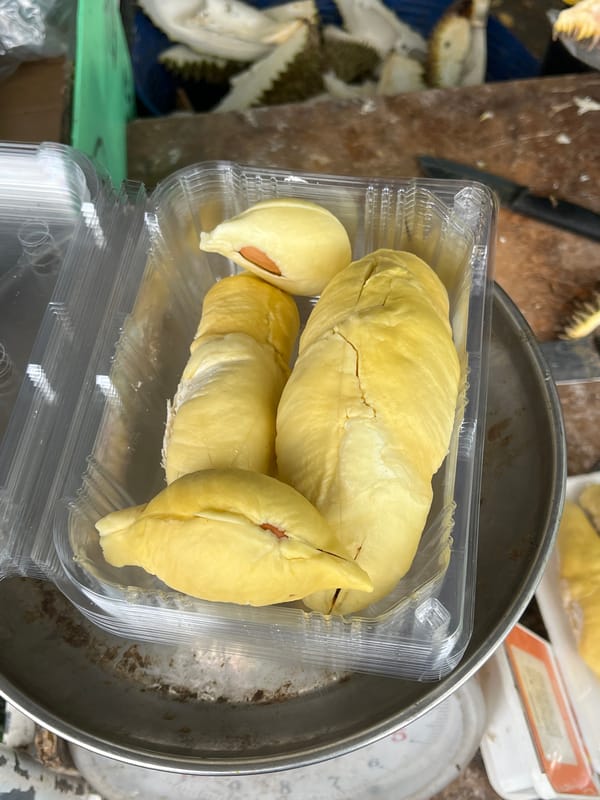 Durian stall in Rawai selling fresh-cut fruit and mangosteens