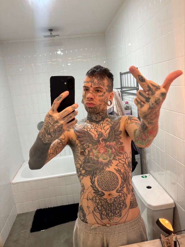 Heavily tattooed person takes bathroom selfies in Buenos Aires