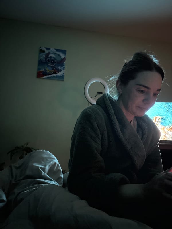Woman documents late evening smartphone session in Russian bedroom