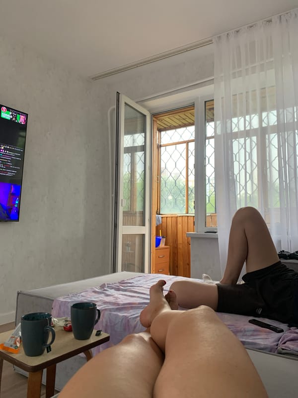 Rainy morning indoors in Perm, cat cuddles and wet windows