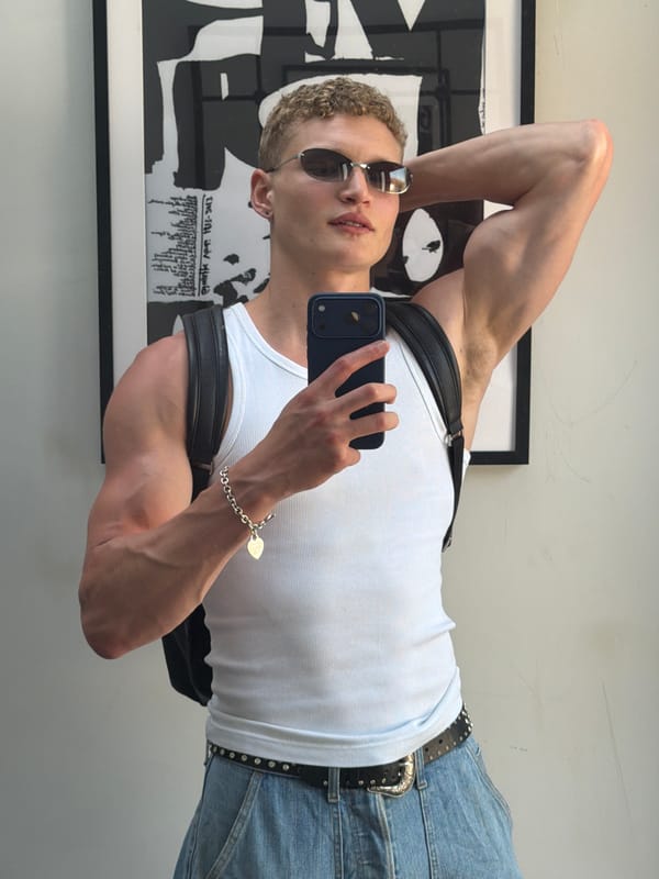Man takes mirror selfie in London wearing sunglasses