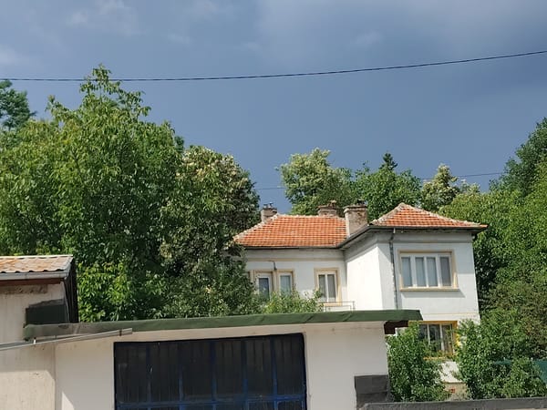 Storm clouds gather over Gabrovo's hills and valley streets