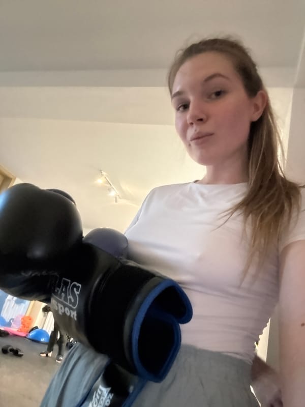 Woman displays boxing gloves in Belgrade