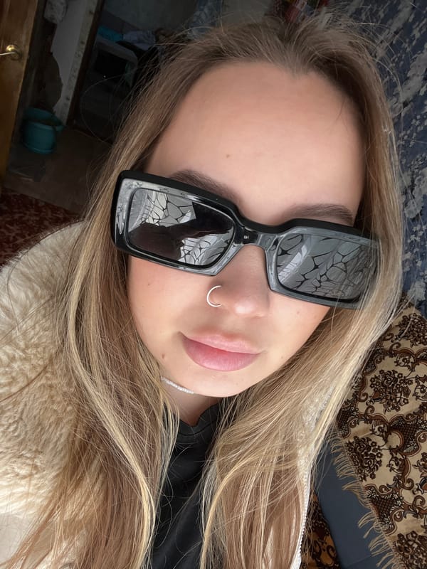 Person takes selfies, rests indoors in Novopokrovskaya