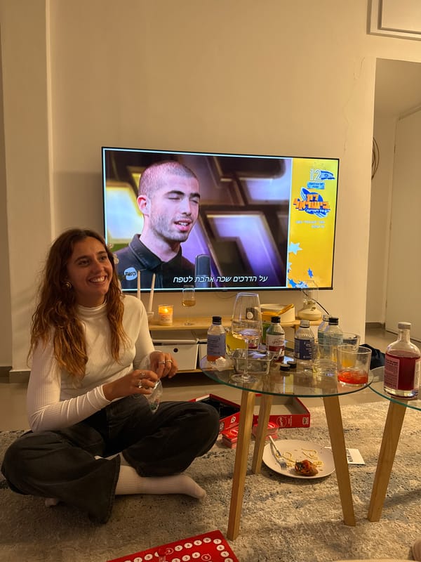 Woman relaxes watching TV in Tel-Aviv home