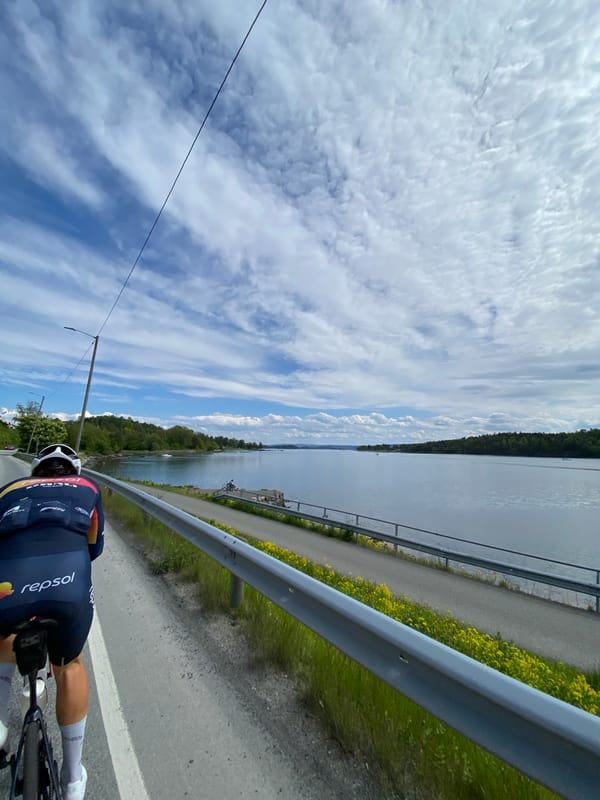 Cyclist rides waterfront path in Asker, Norway
