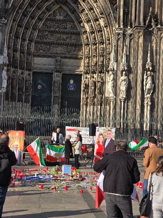 Flag-carrying demonstrators gather at Cologne Cathedral in afternoon protest