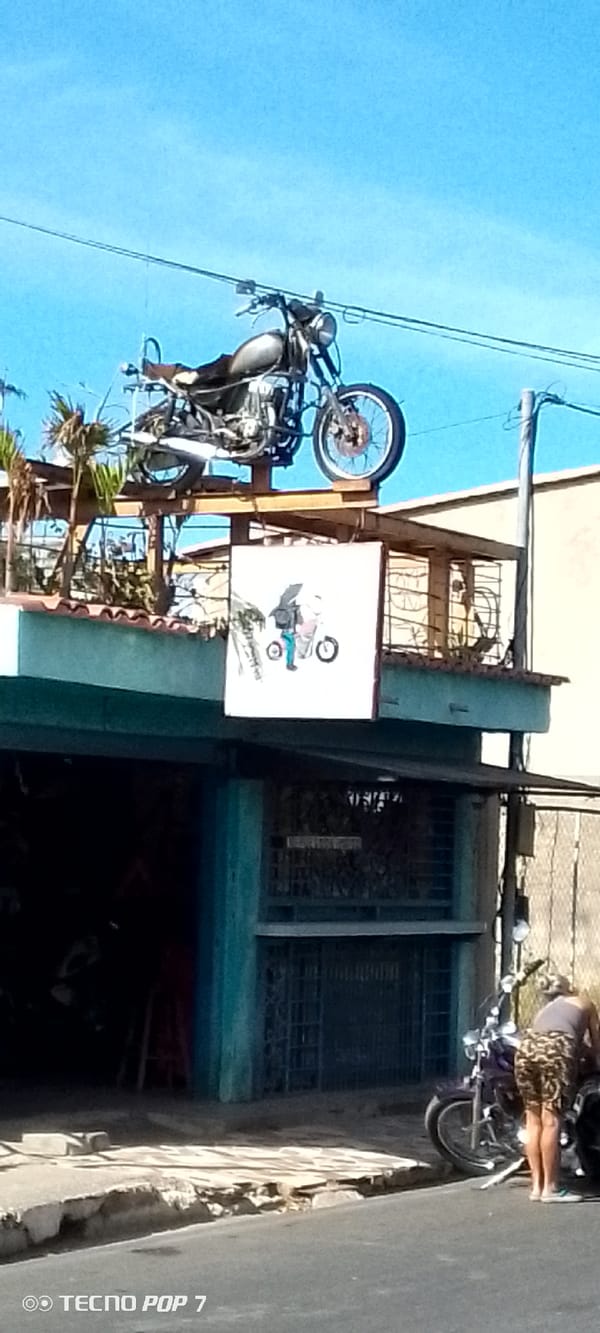 Motorcycle displayed on rooftop platform in Altagracia, Venezuela