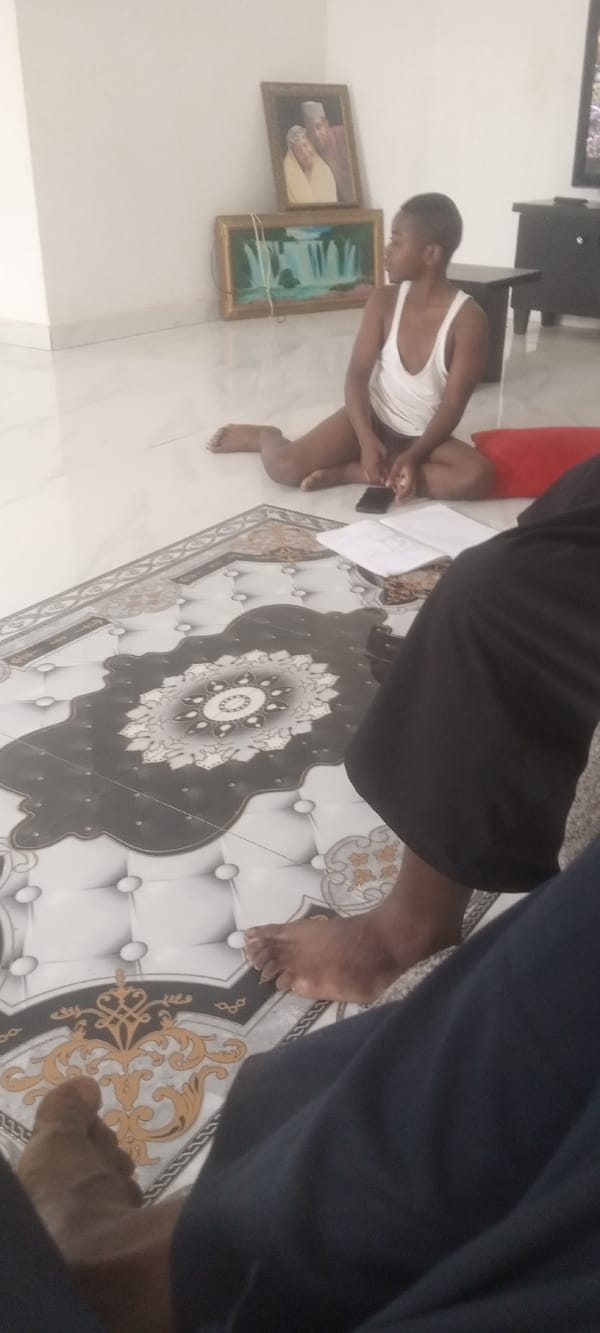 Young person photographed reading indoors in Narayi, Nigeria