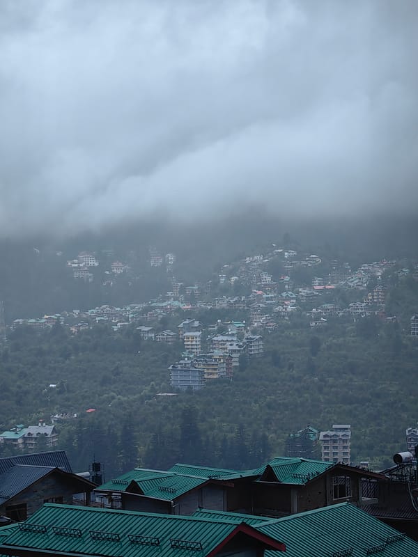 Rainy morning in cloud-covered Vashisht, construction and daily life persist