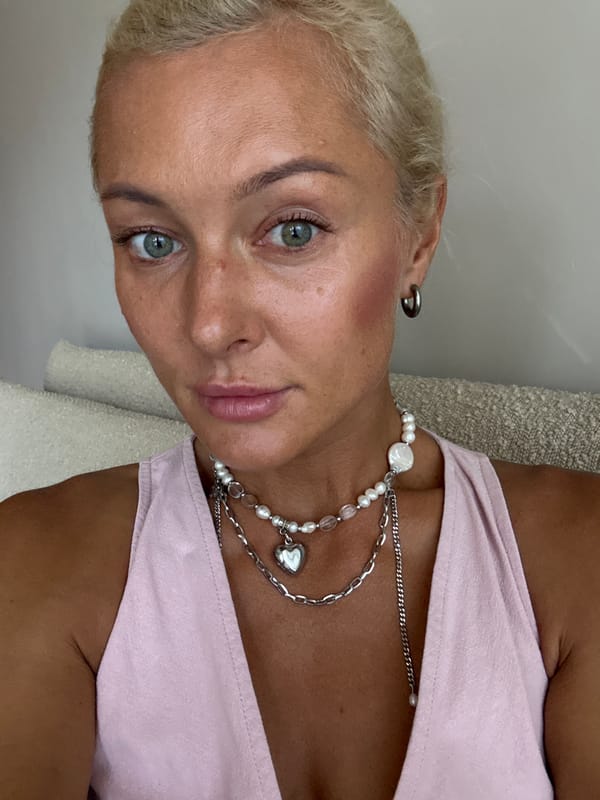 Pink dress, pearl necklaces, selfies from indoors to outside