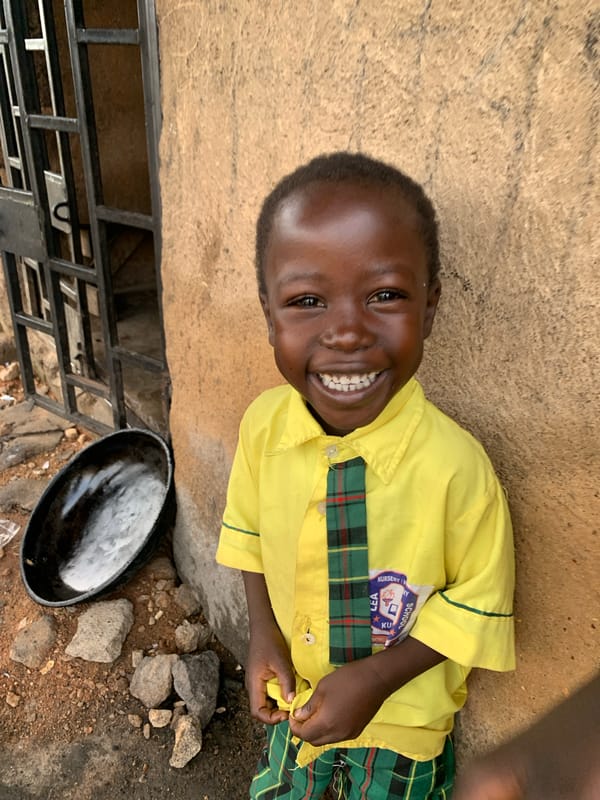 Morning street life in Jos, Nigeria, school uniforms and all.
