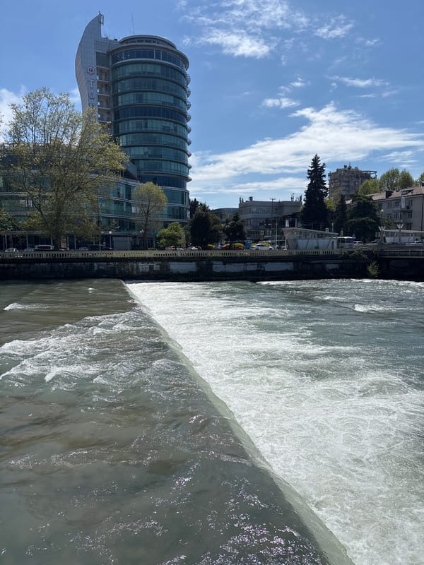 Water flows over river dam in Sochi, Russia