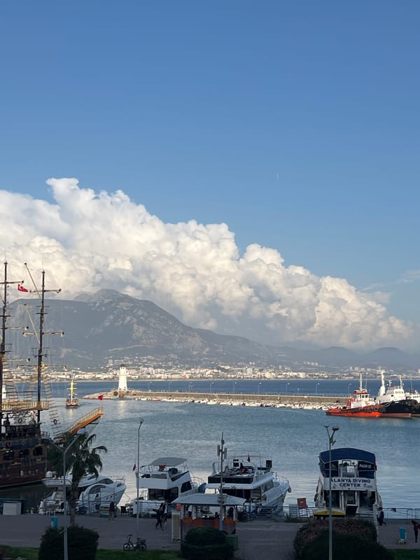 Tourist captures Alanya harbor views and nautical souvenir displays