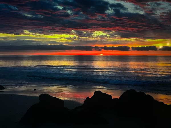 Ocean sunrise/sunset with dramatic sky observed at coordinates 666