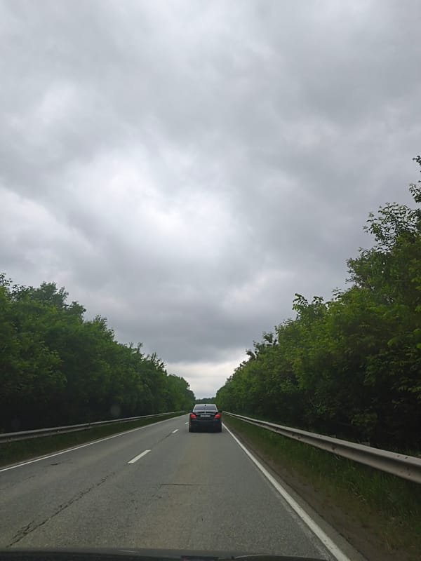 Vehicle travels cracked asphalt road in Niva, Russia