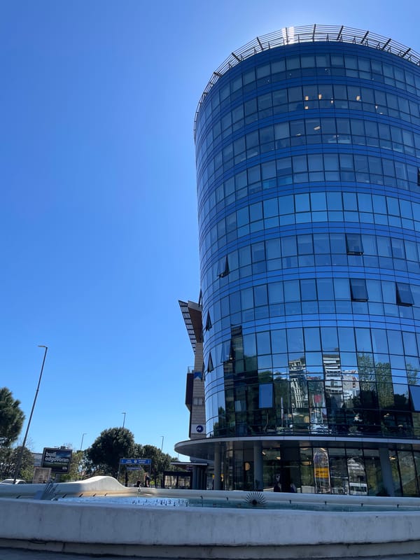 Modern curved blue-glass building observed in Podgorica, Montenegro