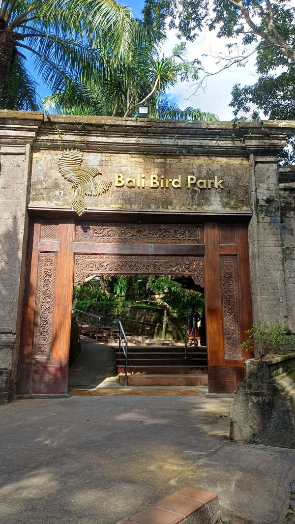 Tourist captures Bali Bird Park's ornate entrance in Sukawati