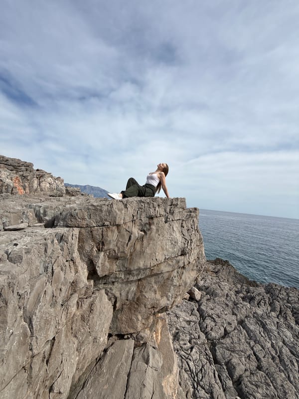 Woman rock climbing on coastal cliffs near Boreti, Montenegro
