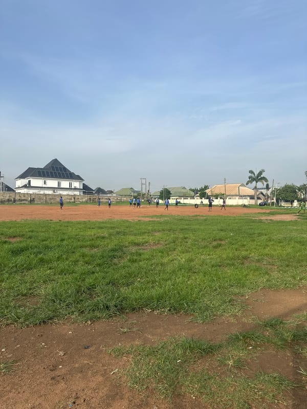 Football session on a dirt field in Abuja, Nigeria