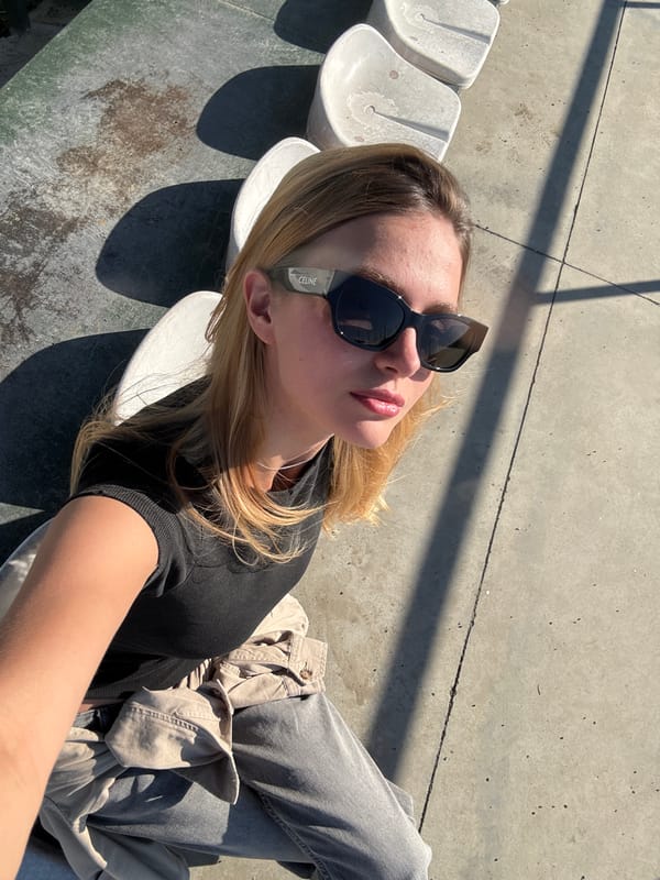 Woman takes selfies at Dinamo Arena on sunny day