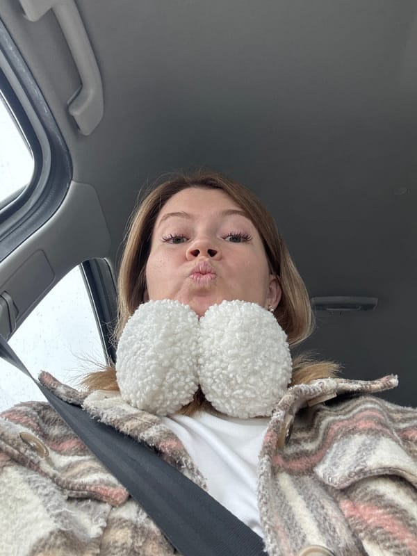 Woman photographed in vehicle wearing earmuffs in Foteni, Russia
